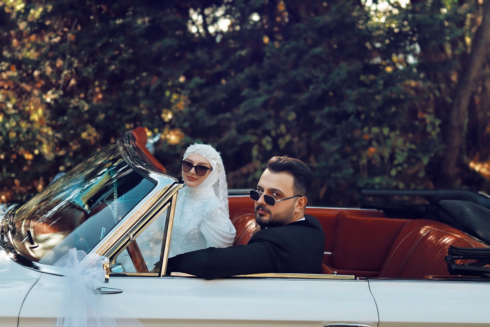 Bride and groom in a classic convertible