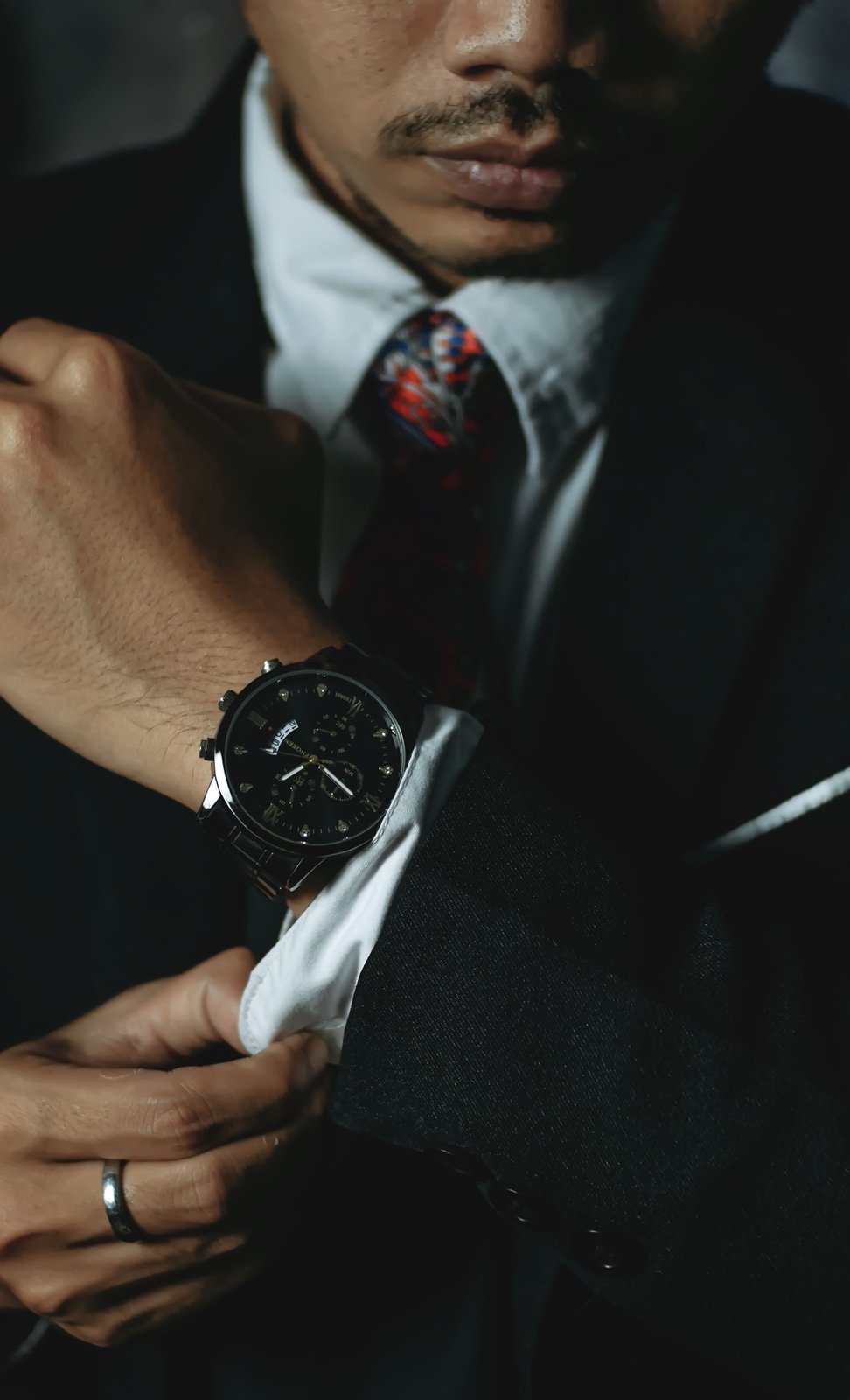 Groom adjusting his cuff and watch